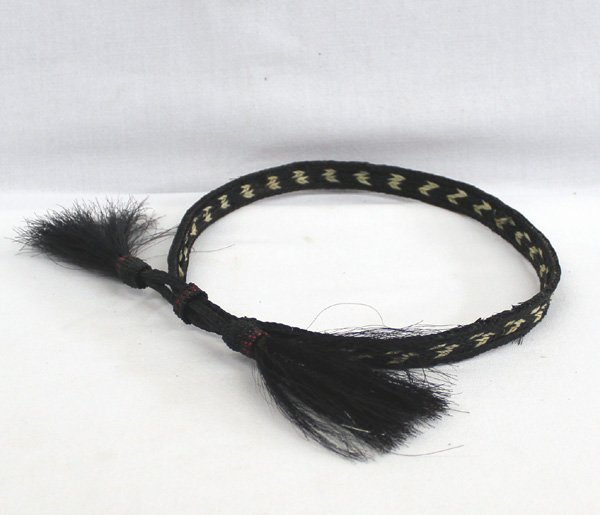 Cowboy Horse Hair Hat Band: Cowboy Horse Hair Hat Band. This is a unique two toned Hat band woven in continuous pattern with beading on ends and tie. This sweet item is adjustable and approx. 29''L x 5/8''W with tassels that are