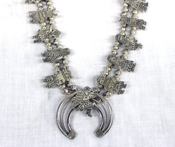 Hopi Sterling Kachina Squash Blossom Necklace: From the Collection of Nick and Suzanne Nicholas. Hopi Sterling Kachina Squash Blossom Necklace, measures 27 in. end to end, naja measures 2 in. x 2 in. and features an eagle kachina, kachina blossoms