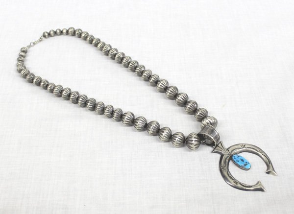 Navajo Sterling Turquoise Naja Necklace - Mitchell: Navajo Sterling Turquoise Naja Necklace - E. S. Mitchell, measures 24'' end to end, largest bead .75'', naja 3.5''L x 2.25''W, melon stamped graduated hollow beads, hand stamped naja with turquoise ca