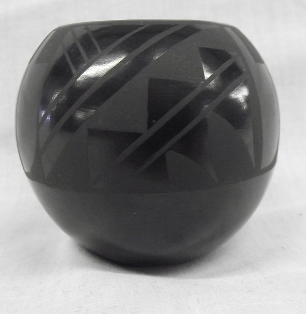 Santa Clara Black on Black Etched Bowl Sisneros: From the Collection of Nick and Suzanne Nicholas. 1987 Santa Clara Black on Black Etched Bowl by Merton and Linda Sisneros, measures 2.5 in. x 2.25 in., Merton and Linda Sisneros (Santa Clara) are a m