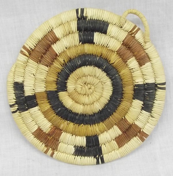 Hopi Tri-colored Dog Head Basket Placque: From the Collection of Nick and Suzanne Nicholas. Hopi Dog Head Basket Tri Colored Placque, measures 6.5 in.