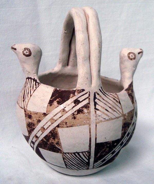 1950s Acoma Double Bird Basket Pottery: From the Nick and Suzanne Nicholas Collection we have a 1950s Acoma Double Bird Basket Pottery, measures 4'' x 4.5'', features geometric and line designs, and opposing bird heads on rim, signed on bot
