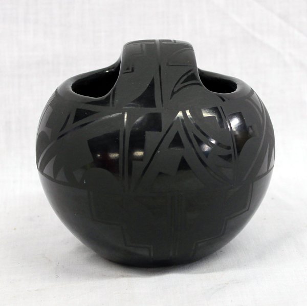 Santa Clara Pueblo Jar by Margaret Garcia: From the Collection of Nick and Suzanne Nicholas we have a Black on Black Santa Clara Pueblo Jar by Margaret Garcia, measures 4.5''H x 5.25''W, handled, features both geometric and abstract designs, s