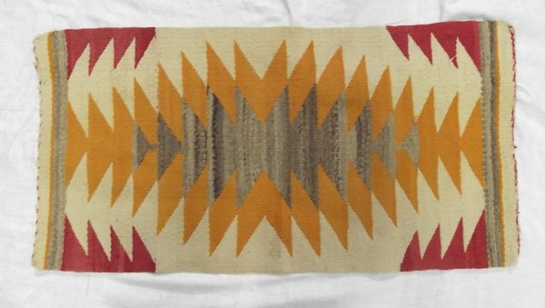 1940 Navajo Serrated Diamond Rug: From the Collection of Nick and Suzanne Nicholas. Navajo Rug, measures 33.5 in. x 17 in., tassles are present and in good condition for age.