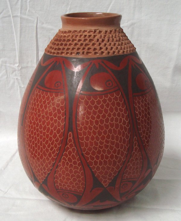 Mata Ortiz Fish Olla by Daniel Gonzalez: Mata Ortiz Fish Olla by Daniel Gonzalez, measures 10.5''H x 8''W, has somewhat of an M.C. Escher feel to it, fish encircle entire body of jar, sgraffito etched fish scales, textured neck, geometric an