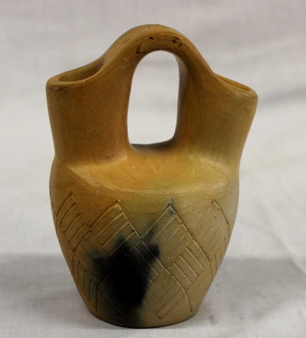 Taos Micaceous Clay Wedding Vase: From the Nick and Suzanne Nicholas Collection we have a Taos Micaceous Clay Wedding Vase, measures 4.5''H x 3.5''W, has fire cloud on lower third of pot, features sgraffito rectangular etchings on bot