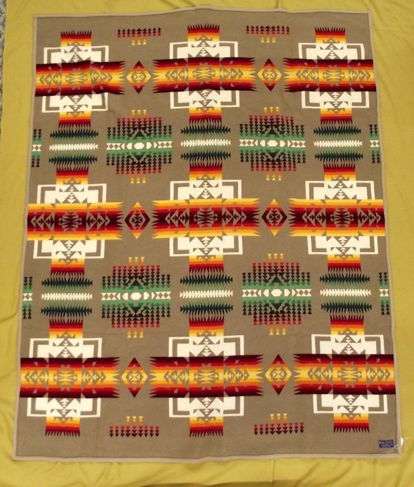 Pendleton Chief Joseph Blanket: Pendleton Chief Joseph Blanket, measures 62'' x 74'', camel brown border, beautiful sunset hues and camel brown and cream background, has original Pendleton Beaver State tag
