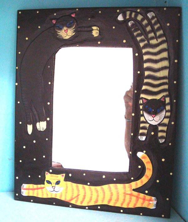 Folk Art Albizia Wood Framed Cat Mirror.: Folk Art Albizia Wood Framed Cat Mirror. The Albizia tree One of the fastest growing of all tree species. This truly Unique mirror measures approx 14''H x 11.25''W.