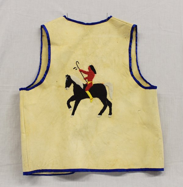 Plains Indian Beaded Leather Vest: Plains Indian Beaded Leather Vest, size medium, blue silk border, shell buttons with leather attachments, back of vest is beautifully beaded and depicts Native American rider on horseback, beautiful s