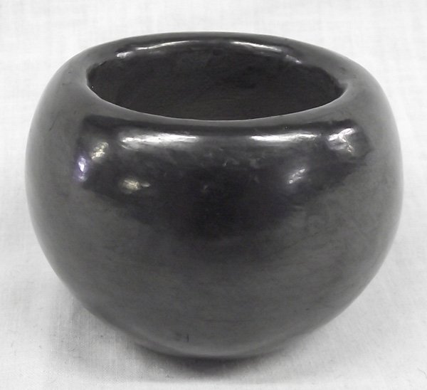 Santa Clara Solid Black Bowl by Anita Sisneros: From the Collection of Nick and Suzanne Nicholas. Santa Clara Solid Black Bowl by Anita Sisneros, measures 2 and 5 eighths in. x 1.75 in., thick walled