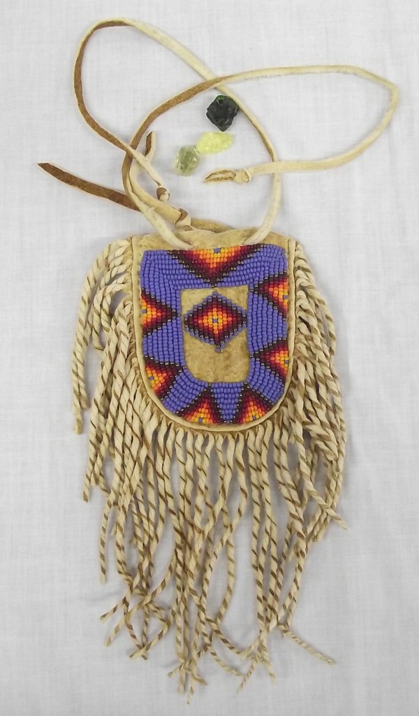 Plains Indian Beaded Fringed Seed Pouch: From the Collection of Nick and Suzanne Nicholas. Plains Indian Beaded Fringed Seed Pouch, 3.25 in. pouch and 7 in. with fringe, beautifully beaded in lavender, burgundy, yellow, orange, and white, st