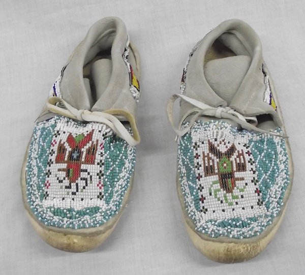 Commercial Leather Beaded Moccasins: From the Collection of Nick and Suzanne Nicholas. Commercial Leather Beaded Thunderbird Moccasins, beautifully beaded in white, red, black, yellow, baby blue, cobalt blue, yellow, green, and burgundy,