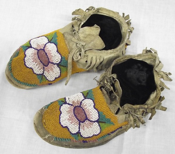 Antique Nez Perce Beaded Flower Moccasins: From the Collection of Nick and Suzanne Nicholas. Antique Nez Perce Beaded Flower Moccasins, flower designs beaded in lavender, white, sea foam green, orange, and cobalt blue, measures 9 in. end to en