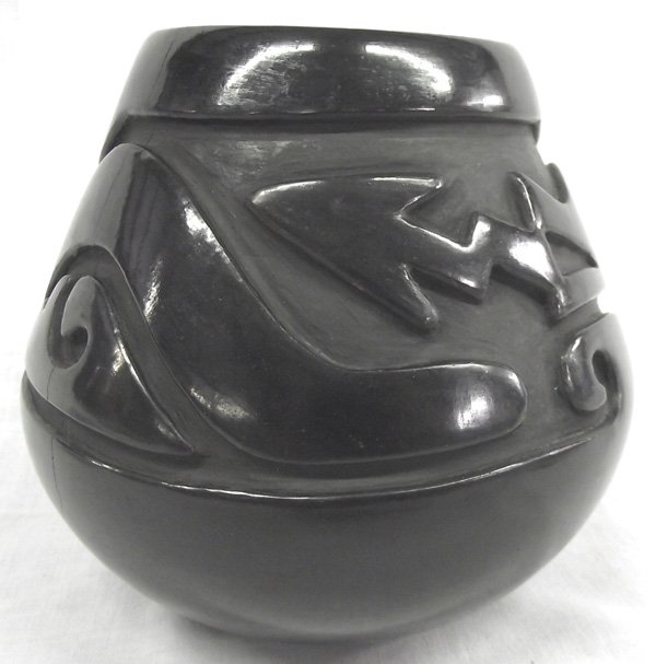 Santa Clara Pueblo Carved Jar by Mary Cain: From the Collection of Nick and Suzanne Nicholas we have a gorgeous Santa Clara Pueblo Carved Jar by Mary Cain, measures 6.25''W x 5.75''H, deeply carved featuring Avanyu (the Sea Serpent), signed on 
