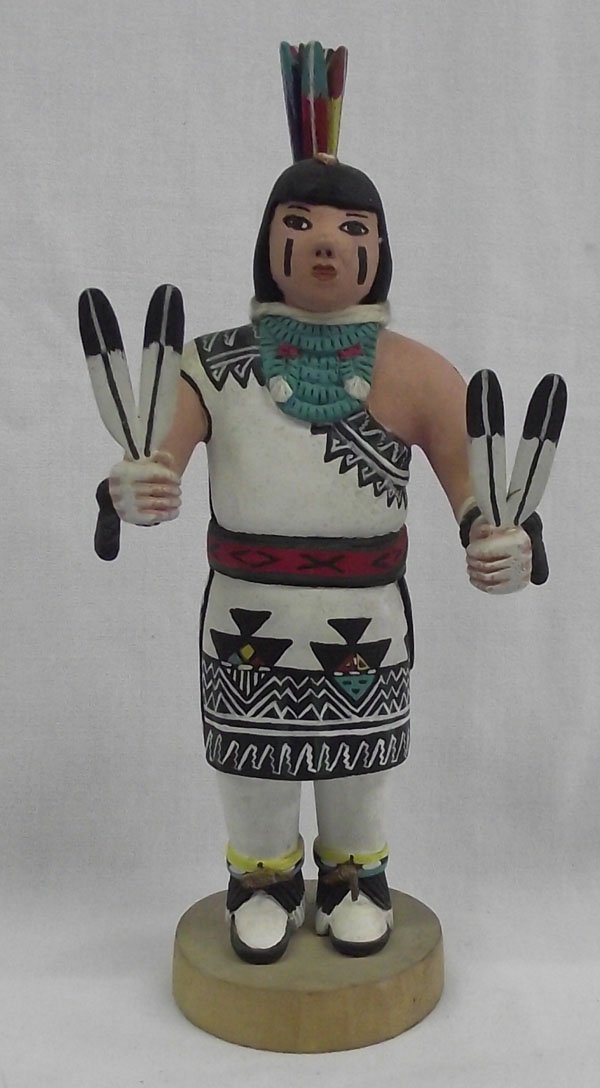 Hopi Kachina ''Tewa Girl'' by Ben Seeni: From the collection of Nick & Suzanne Nicholas. Hopi Kachina ''Tewa Girl'' by Ben Seeni (First Mesa), measures 10.5'' high x 4.5'' wide. Beautifully painted with turquoise collar, holding feathers. Ni