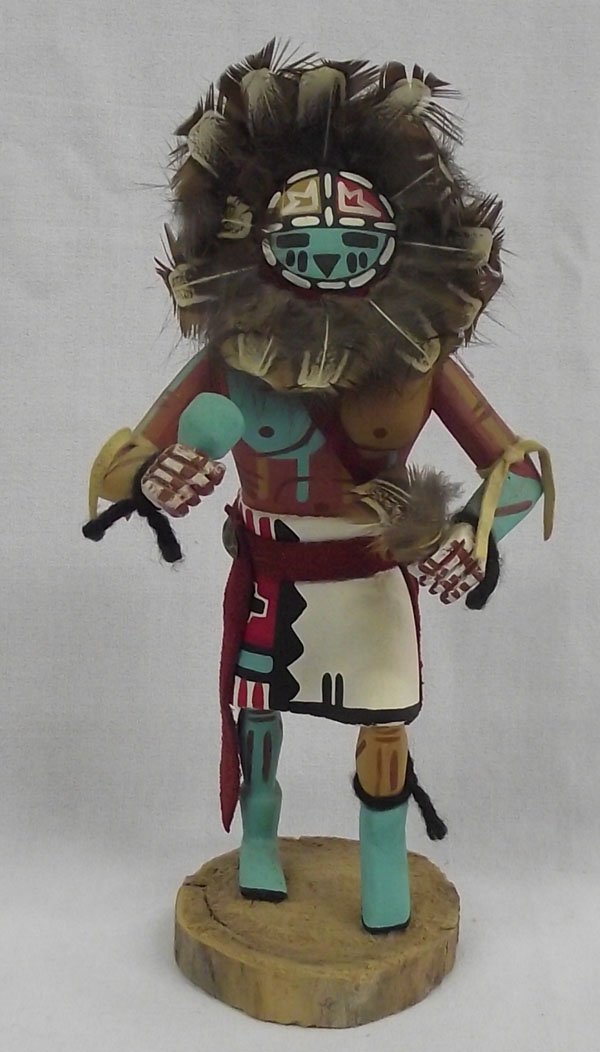 Hopi Sunface Kachina by Ben Yazzie: From the collection of Nick & Suzanne Nicholas. Hopi Sunface Kachina by Ben Yazzie. Measures 9'' high x 4.25'' wide. Great feather decoration, signed.