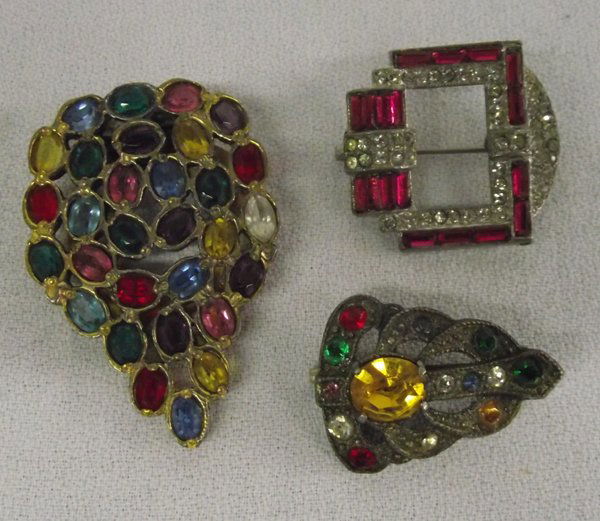 Art Deco DeRosa Clip & Rhinestone Pins: From the Proctor Collection Silver City, NM, Designer R. DeRosa signed clip with multi set in a grape like cluster, measures 2 x 1.5 inches. Also there are 2 pins, one rhinestone & ruby colored stones
