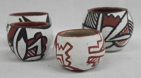 Four Mini Acoma Polychrome Pots: From the collection of Nick & Suzanne Nicholas. Four Mini Acoma Polychrome Pots, largest measuring 1.25'' x 1 5/8'', smallest 1'' high x 1.25'' wide. Sweet collection!