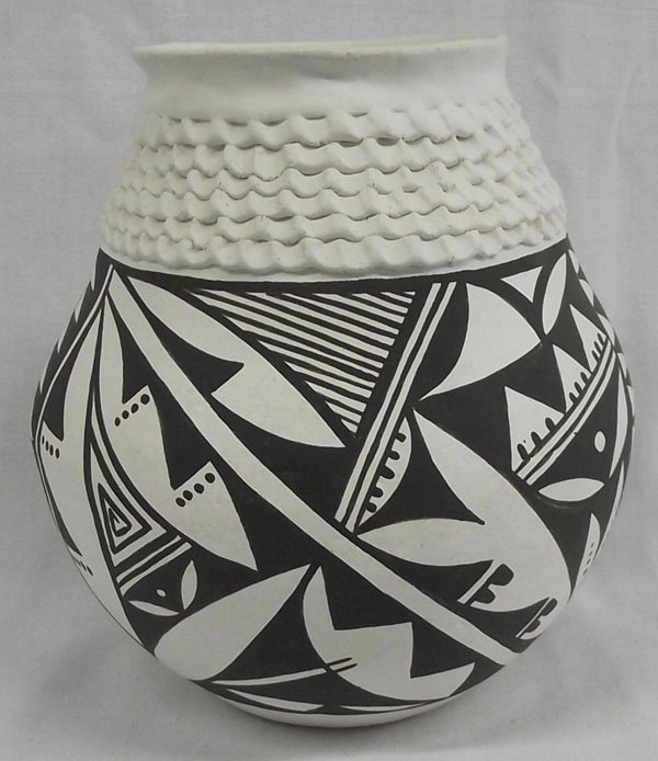 Acoma Jar by Norma Jean Ortiz: From the Nick and Suzanne Nicholas Collection we have an Acoma Jar by Norma Jean Ortiz, traditional black on white abstract and geometric Native American designs, measures 7.5''H x 7.25''W, highly tex