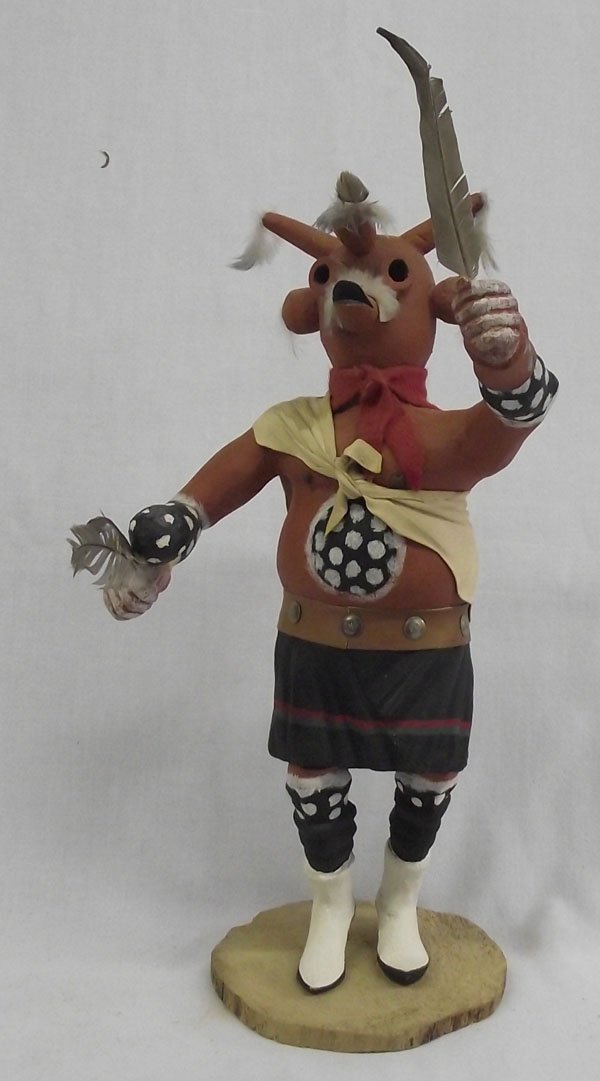 Hopi Mudhead Kachina by Lemuel Poola: From the Nick and Suzanne Nicholas we have a Hopi Mudhead Kachina by Lemuel Poola, embellished with feathers and wearing a leather top and hand painted dance kilt, Lemuel Poola is an older carver from