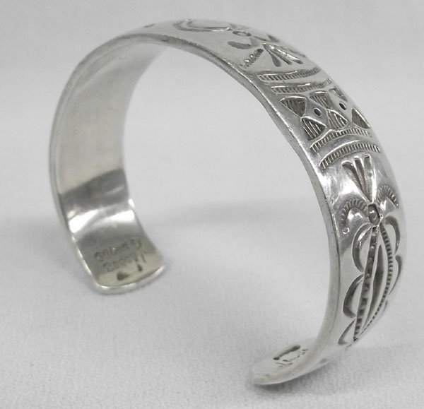 Navajo Sterling Silver Bracelet by Gilbert Begay: Navajo Sterling Silver Bracelet by Gilbert Begay. Sterling silver, nice weight, hallmarked ''Gilbert Begay'' ''Sterling''. All stamped in the traditional style. Measures 6.75'', including opening x 3/