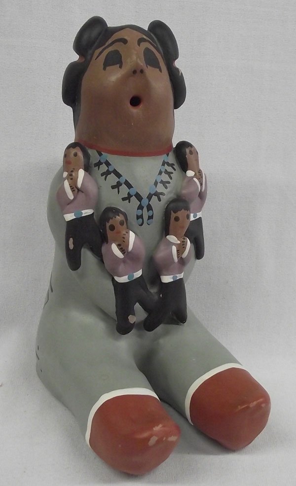 Large Hopi Storyteller Figure: From the collection of Nick & Suzanne Nicholas. Large Hopi Storyteller Figure, measuring 7.5''h x 3.5''w, 6'' long. Unsigned. Has a couple glaze chips on her toes, but beautifully painted with 4 child