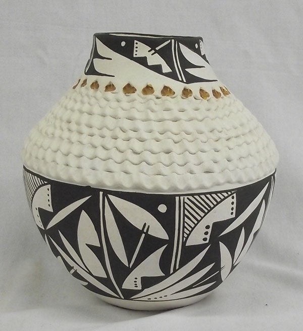 Acoma Jar by Norma Jean Ortiz: From the Nick and Suzanne Nicholas Collection we have an Acoma Jar by Norma Jean Ortiz, measures 7.5''H x 7.75''W, features beautiful black and white geometric and abstract designs encircling rim as w