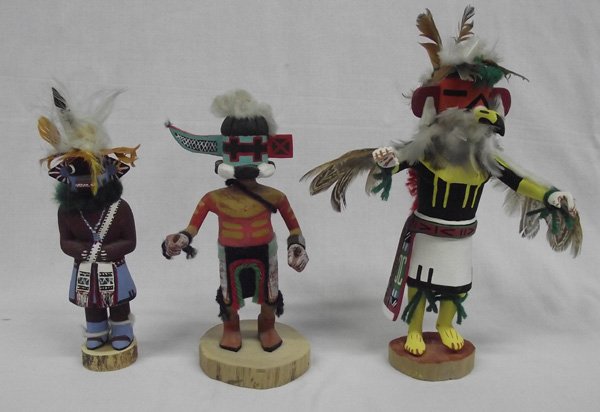 Collection of Navajo Kachinas: From the Nick and Suzanne Nicholas Collection we have 3 Navajo Kachinas, largest measures 10'' x 8'' (includes feathers), #1 wearing yarn and felt loin cloth, painted red and maize colored designs on 