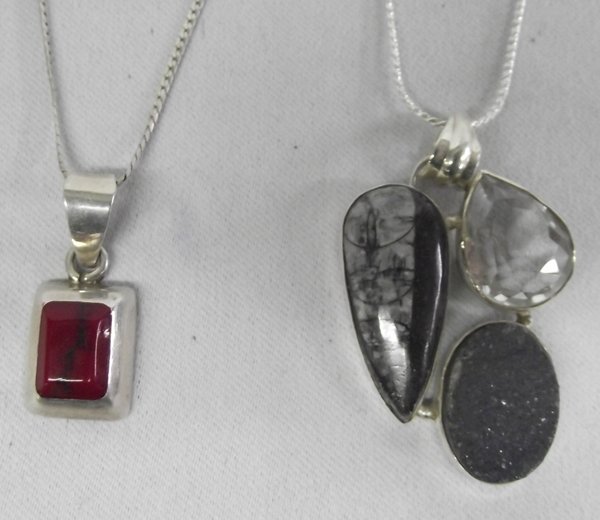 Two Necklaces, Sterling w/Coral, Druzy, Fossil: Two Necklaces, Sterling w/Coral, Druzy, Fossil and Topaz. The first necklace is from Mexico, stamped ''925'', features a square cut piece of coral on a sterling silver chain, measuring 26. The second