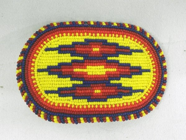 Plains Indian Beaded Belt Buckle: Plains Indian Beaded Belt Buckle, underside lined with doeskin, vibrant colored beads in a geometric Native American design, measures 2.5'' x 3.5''
