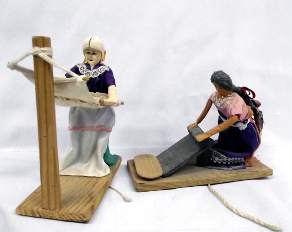 Pair of Native Pull String Working Dolls: Pair of Native Pull String Working Dolls. 1)Gray haired lady grinds when the string is pulled. She measures 5.H x 6''L. 2) This doll measures 6''H x 5''W and bends to weave when the string is pulled.