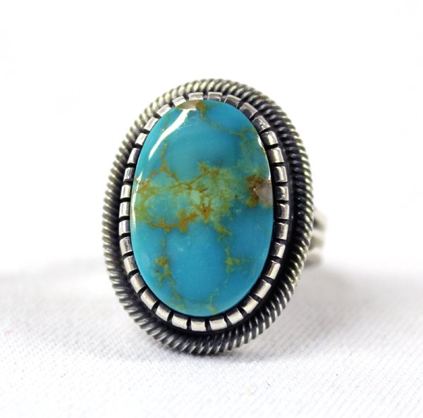 Navajo Sterling & Turquoise Ring by Martinez: Navajo Sterling & Turquoise Ring by Martinez. Beautiful polished turquoise cabochon with tan matrix. Triple shank, size 6.75, stone measures .75'' x .5'' wide. Stamped ''Sterling'' ''Leon Martinez''.