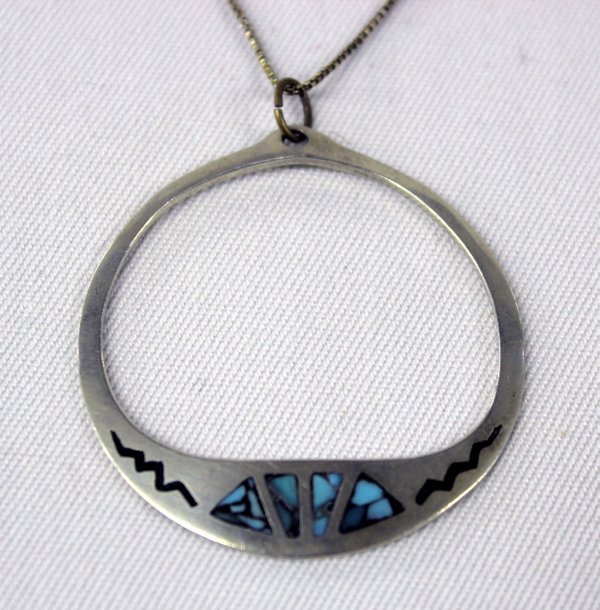 Navajo Sterling & Turquoise Chip Inlay Necklace: Navajo Sterling & Turquoise Chip Inlay Necklace. Sterling hoop pendant is inlay set with turquoise chips. Measures 18'' with sterling chain, pendant measures 1.75'' x 5/8'', marked ''Sterling''.