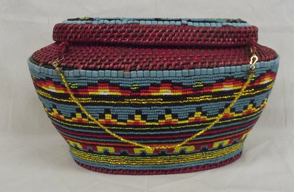 Large Beaded Basket by Kills Thunder: Large Beaded Basket by Kills Thunder. This brightly colored item measures approx. 15.25''L x 8.25''W x 9''H. Kathleen Kills Thunder was born in Seattle, Washington. Kathy has been painting and beading