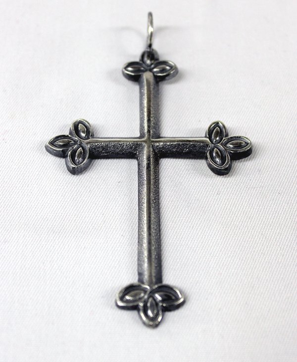 Navajo Sterling Silver Cross by Eugene Mitchell: Navajo Sterling Silver Cross by Eugene Mitchell. Beautiful example of Navajo sand casting, measuring 4.25'' in length and 2.5'' width. Typical trefoil designs on the tips of the cross, symbolizing the