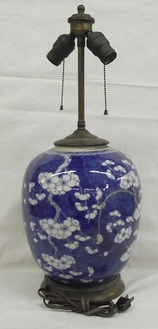 Antique Oriental Blue & White Porcelain Lamp: Vintage Oriental Porcelain Blue & White Lamp. Beautiful example of Chinese porcelain in the distinctive blue and white colors, depicting cherry blossoms. Vintage brass fittings and wiring commensurate