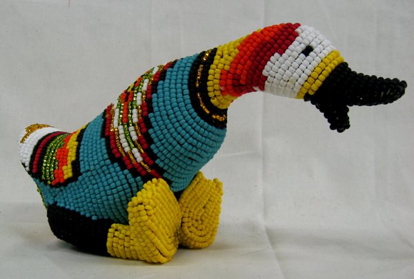 Beaded Duck by Kills Thunder: Beaded Duck by Kills Thunder. This cute piece with it's brightly colored beads measures approx. 5.5''H x 10.5''L. Kathleen Kills Thunder was born in Seattle, Washington. Kathy has been painting and be