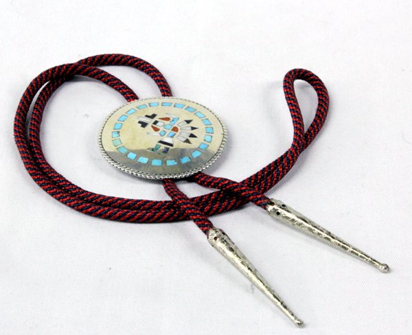Zuni Sterling Inlay Bolo by J. D. Massie: Zuni Sterling Inlay Bolo by J. D. Massie. Beautiful inlay work of a knife wing dancer, using turquoise, mother-of-pearl, jet, coral and abalone. Tie measures 36'', bolo is 2 1/8'' in diameter.