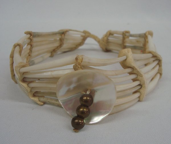 Vintage Dentallium Shell & Rawhide Choker: Vintage Dentallium Shell & Rawhide Choker. Handsome chocker strung with dentallium shells with rawhide spacers. The central shell is abalone with 3 silver beads. Measures 12 1/2'' long x 1 1/2'' wide.