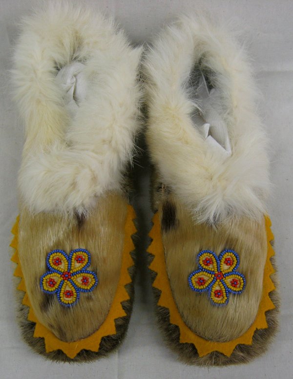 Vintage Inuit Fur and Wooden Sole Moccasins: Vintage Inuit Fur and Wooden Sole Moccasins. Measure 10''L x 4''W. Hand beaded flower designs on top, lined with rabbit skin around ankles. Some fur missing, clean.