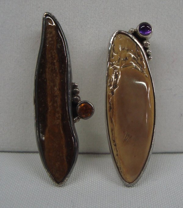 2 Inuit Sterling Silver Mamoth Bone Pendants: Inuit Ivory Pendants, 2 Pieces. Largest pendant measures 2 1/6'' long x 5/8'' wide. One pendant has a citrine stone, the other grape amber, stamped ''925''.