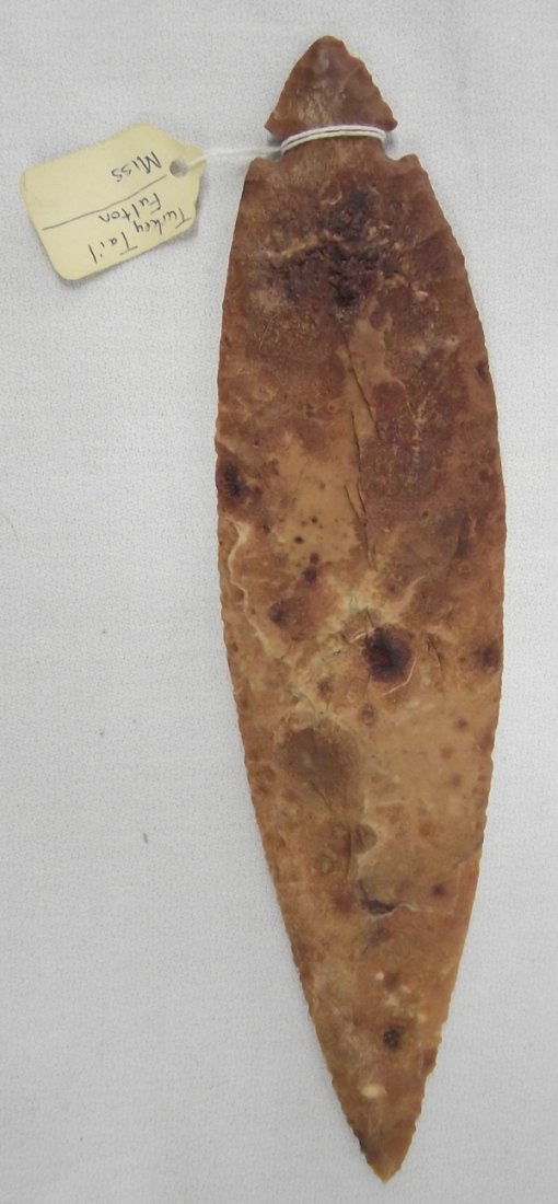 Red Jasper Spearhead Replica Fred Eiserman Estate: Turkey Tail Fulton Style Red Jasper Spearhead Replica from Fred Eiserman Estate. I.D. Tag is from Fred Eiserman that reads ''Turkey Tail Fulton Miss 1000 BC-500 AD''. Measures approx. 9''L x 2''W. Ori