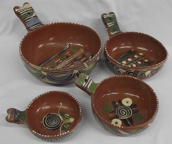 Older Mexican Nested Handled Pottery Bowls: Mexican Nested Handled Pottery Bowls, decorated in typical native style. Largest measures 12'' in length.
