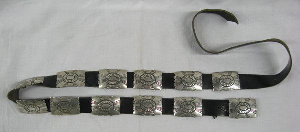 Navajo Sterling Silver Concho Belt by John Delvin: Navajo Sterling Silver Concho Belt on Leather by John Delvin. Conchos are attached on back with copper straps. There are 11 conchos, each measures 1.75'' x 1.25'' & one buckle, that measures approx. 1