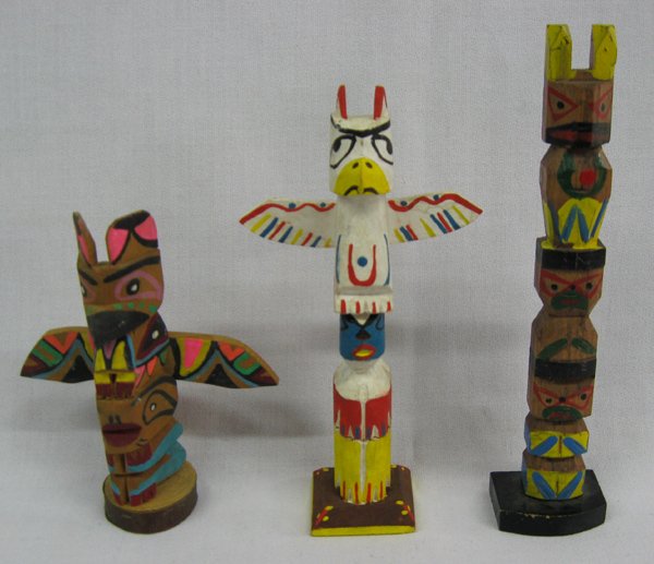 3 Northwest Coast Trading Post Totem Poles: 3 Hand Carved & Painted Totem Poles. One of these brightly painted pieces is signed on the bottom. The largest measures approx. 8.5''H x 2''W.