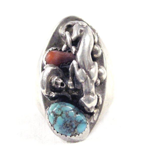Sterling Turquoise Mountain Lion Eating Man Ring: Unusual Heavy Sterling Silver, Turquoise, & Coral Ring showing a Mountain Lion Eating a Man, Size 9 1/2. Heavy solid sterling silver ring measures approx. 1.5"L x 3/4"W.