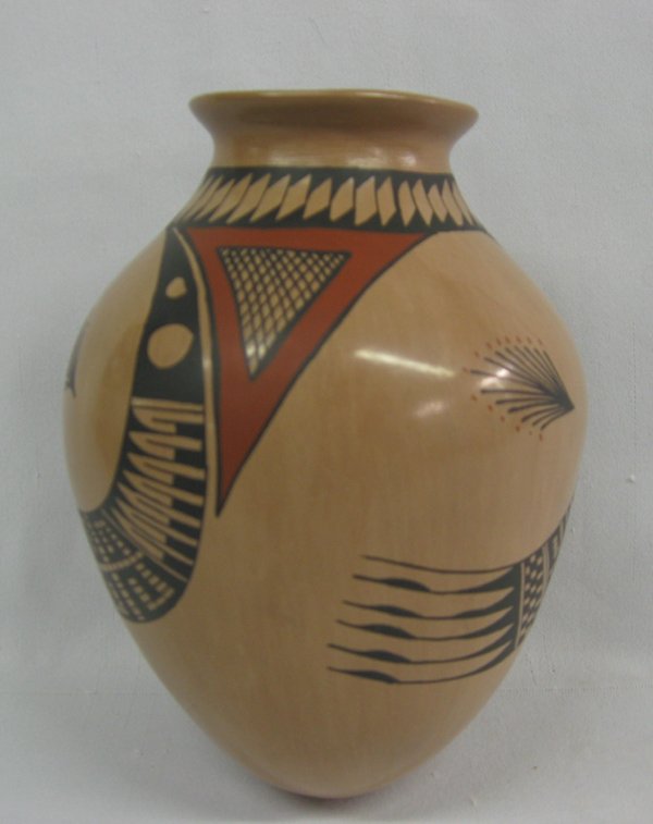 Mata Ortiz Polychrome Jar by Manuel Mora: Mata Ortiz Polychrome Jar by Manuel Mora. Geometric patterns in black, red on a tan background. Measures 7.5''H x 5.75'', signed by Manuel Mora.