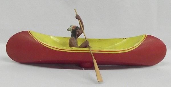 Vintage Wooden Toy Canoe and Native American Brave: Vintage Wooden Toy Canoe and Native American Brave with paddle, measures 9''L x 2''W x 1.75''H, has unreadable hallmark on bottom of canoe