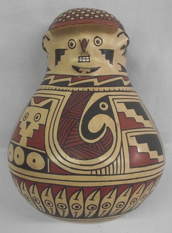 Mata Ortiz Effigy Hooded Pottery Man - Oscar Ortiz: Mata Ortiz Effigy Hooded Pottery Man - Oscar Ortiz. Measures approx. 7 1/2H x 6 1/2''W. There is a small pressure crack on the top of the Eye Dazzler Hat this is on top of his head. There is a stylize