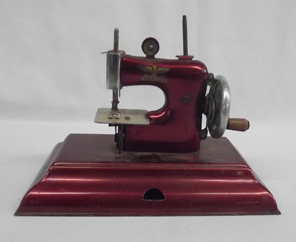 1940s German Casige Child's Toy Sewing Machine: 1940s German Casige Metal Child's Toy Sewing Machine, measures 8.75''L x 5''W x 6.5''H
